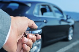 man in suit opening his car with the control remote key