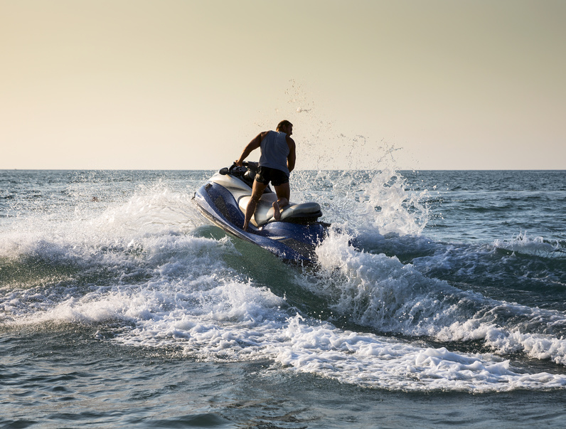 Silhouette of man on jetski at sea