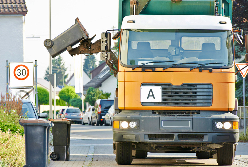 urban municipal recycling garbage collector truck loading waste and trash bin